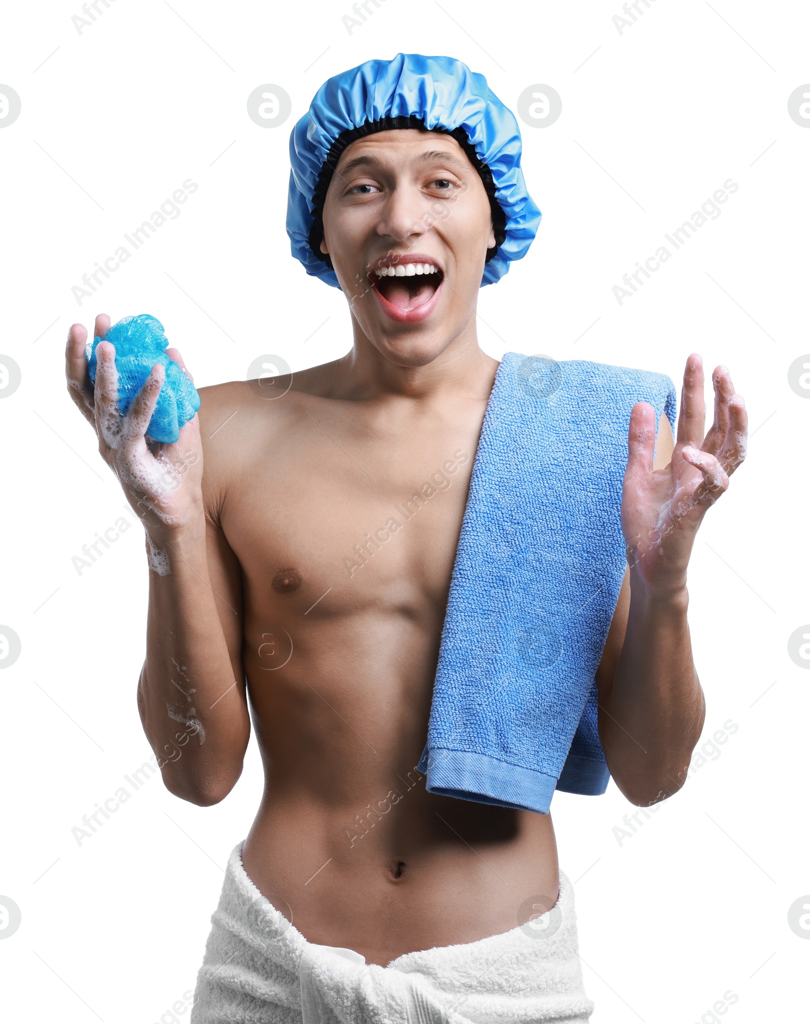 Photo of Happy man with shower cap, towels and mesh sponge on white background