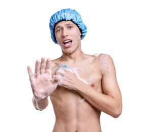 Photo of Man with shower cap and mesh sponge making stop gesture on white background