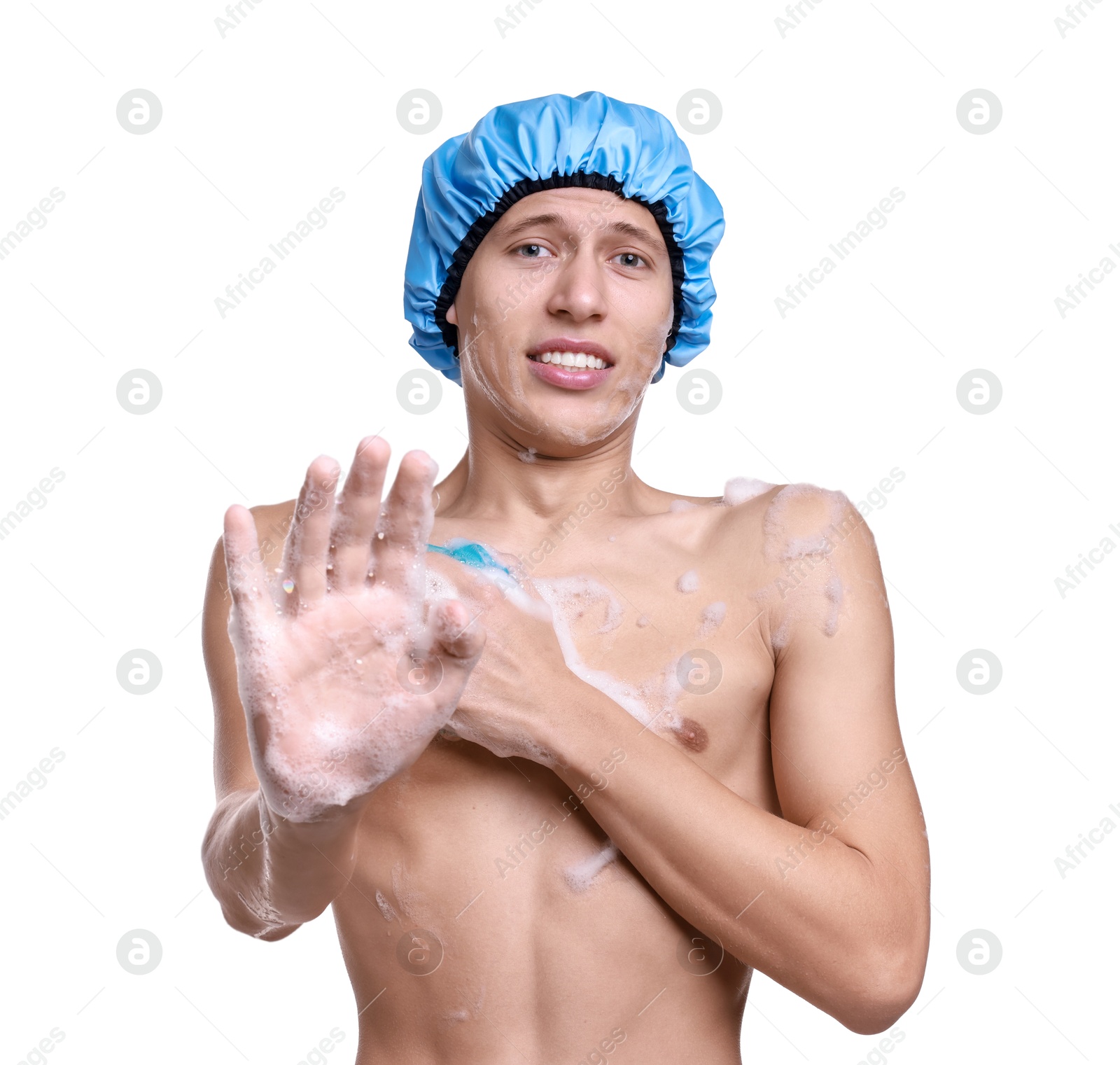 Photo of Man with shower cap and mesh sponge making stop gesture on white background