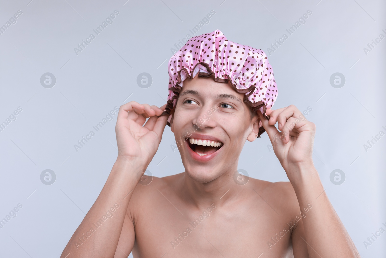 Photo of Man in shower cap on light grey background