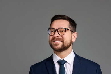 Photo of Portrait of banker in glasses on grey background