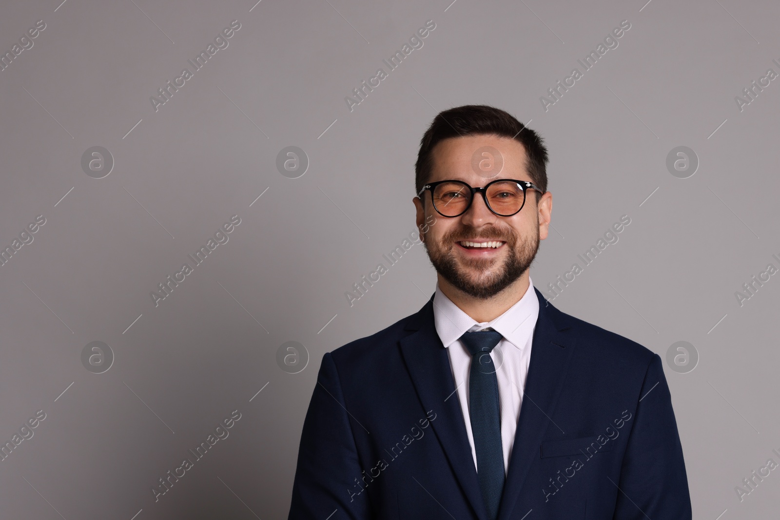 Photo of Portrait of banker in glasses on grey background, space for text