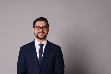 Photo of Portrait of banker in glasses on grey background, space for text