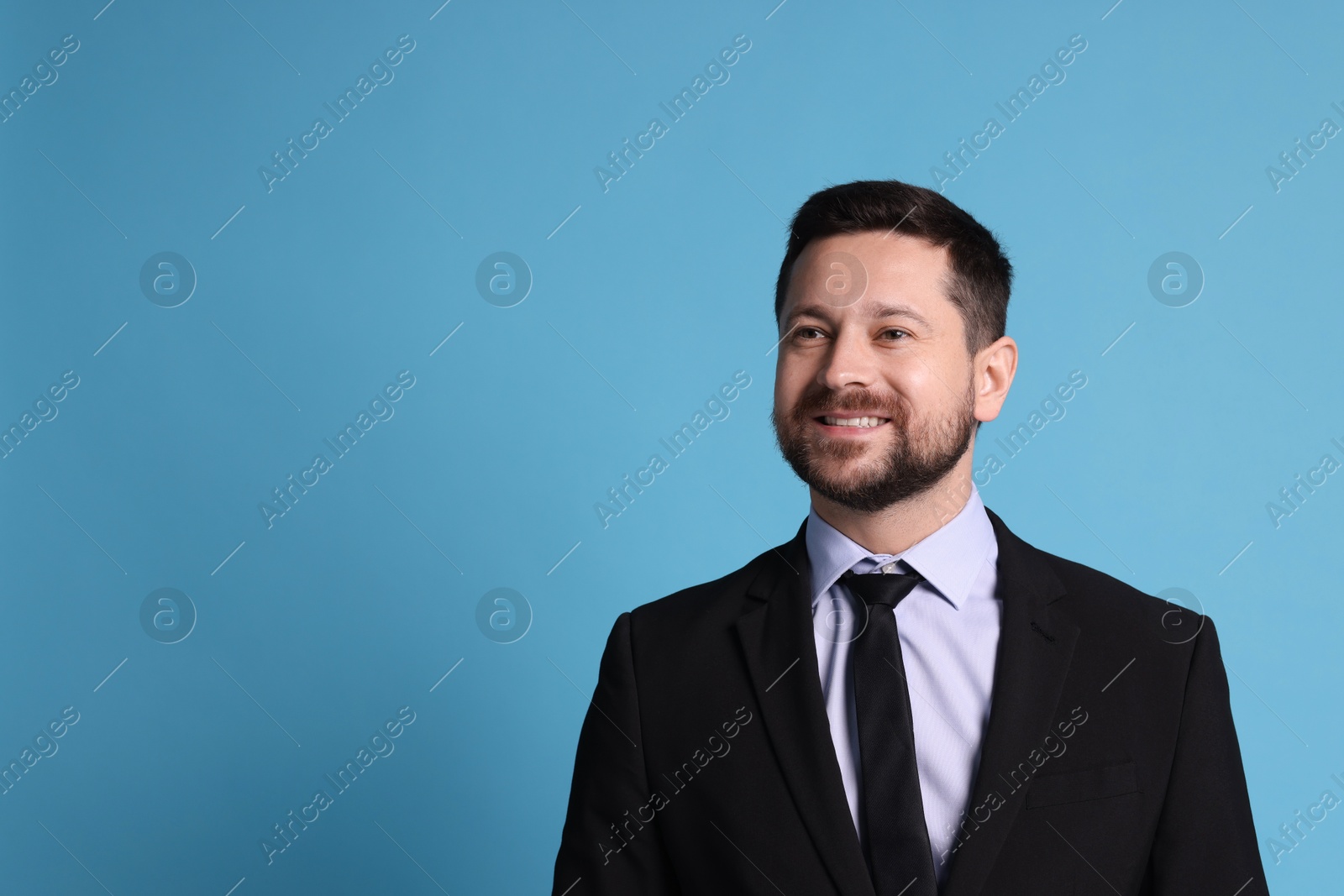 Photo of Portrait of banker on light blue background, space for text