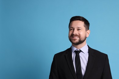 Photo of Portrait of banker on light blue background, space for text