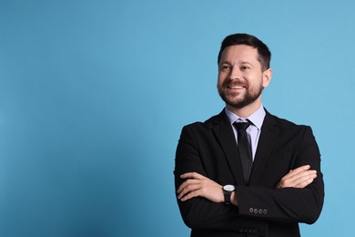 Photo of Banker with crossed arms on light blue background, space for text