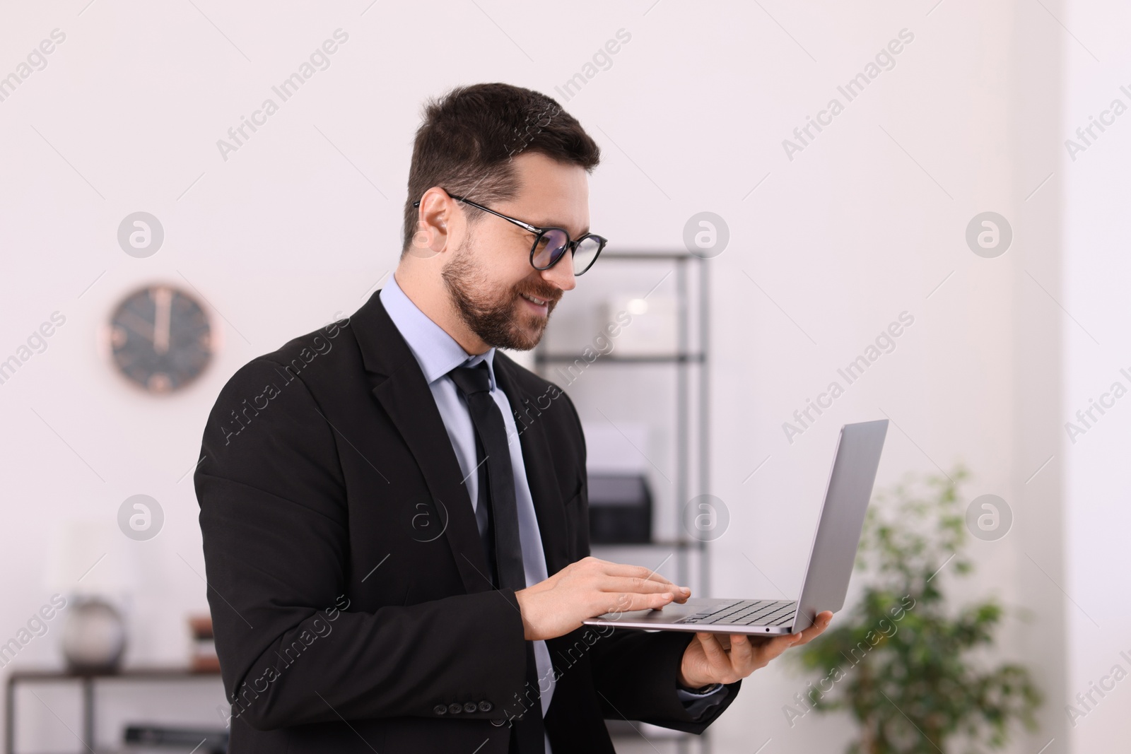 Photo of Portrait of banker using laptop in office