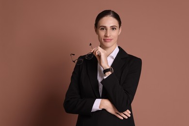 Photo of Portrait of banker with glasses on brown background