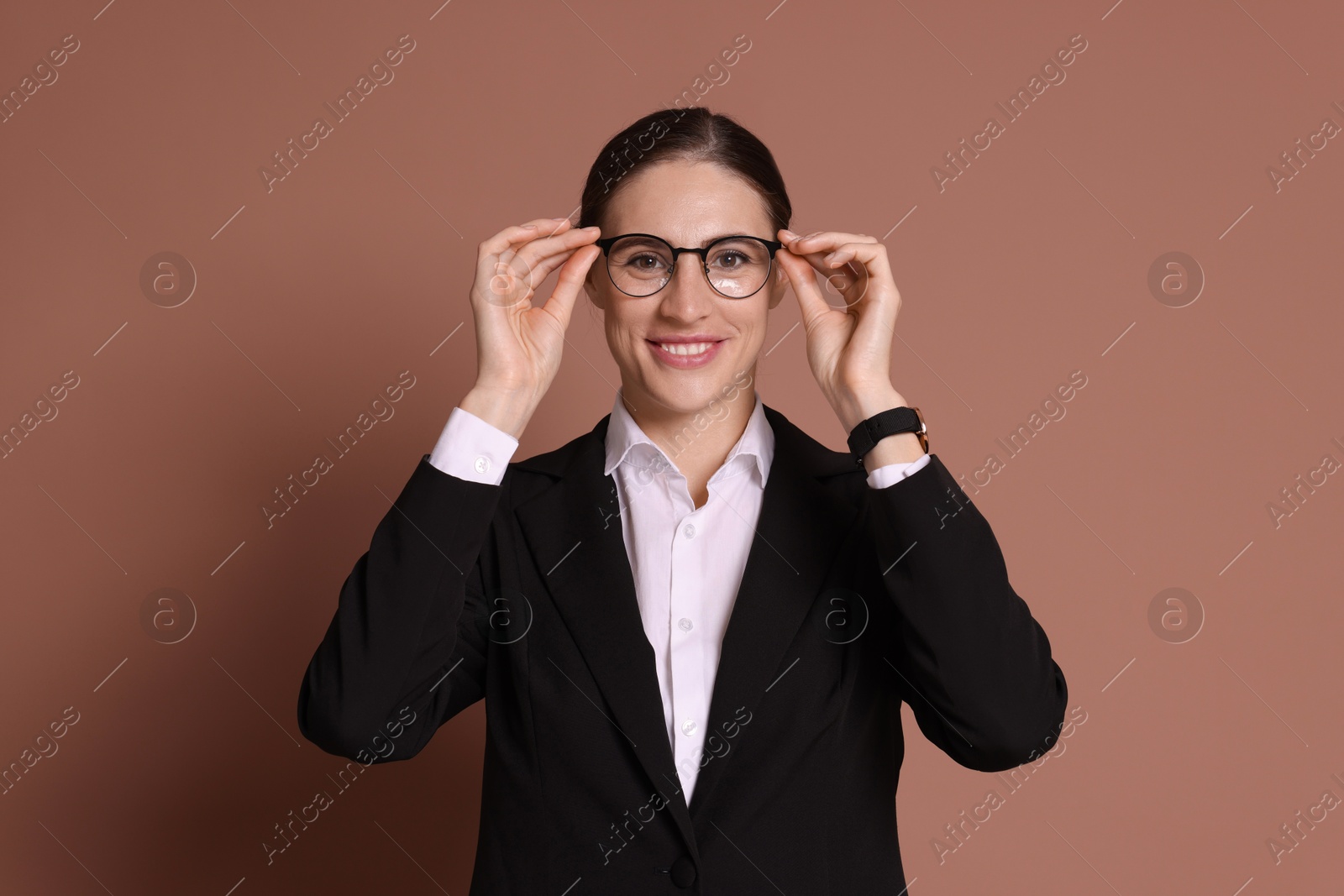 Photo of Portrait of banker in glasses on brown background