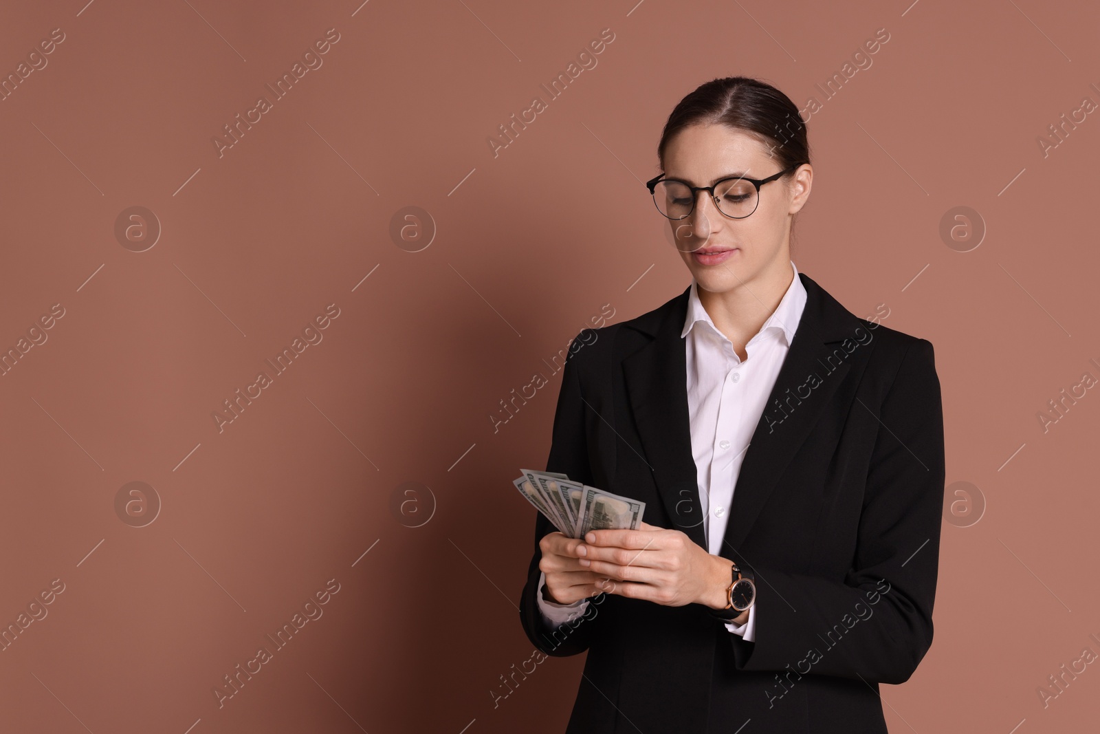 Photo of Banker with dollar banknotes on brown background, space for text