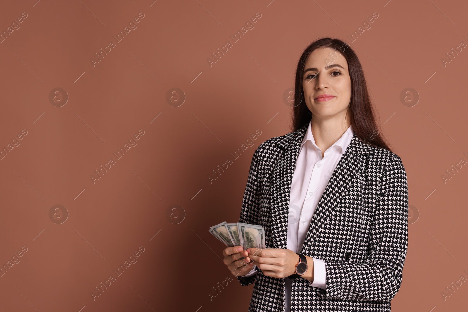 Photo of Banker with dollar banknotes on brown background, space for text