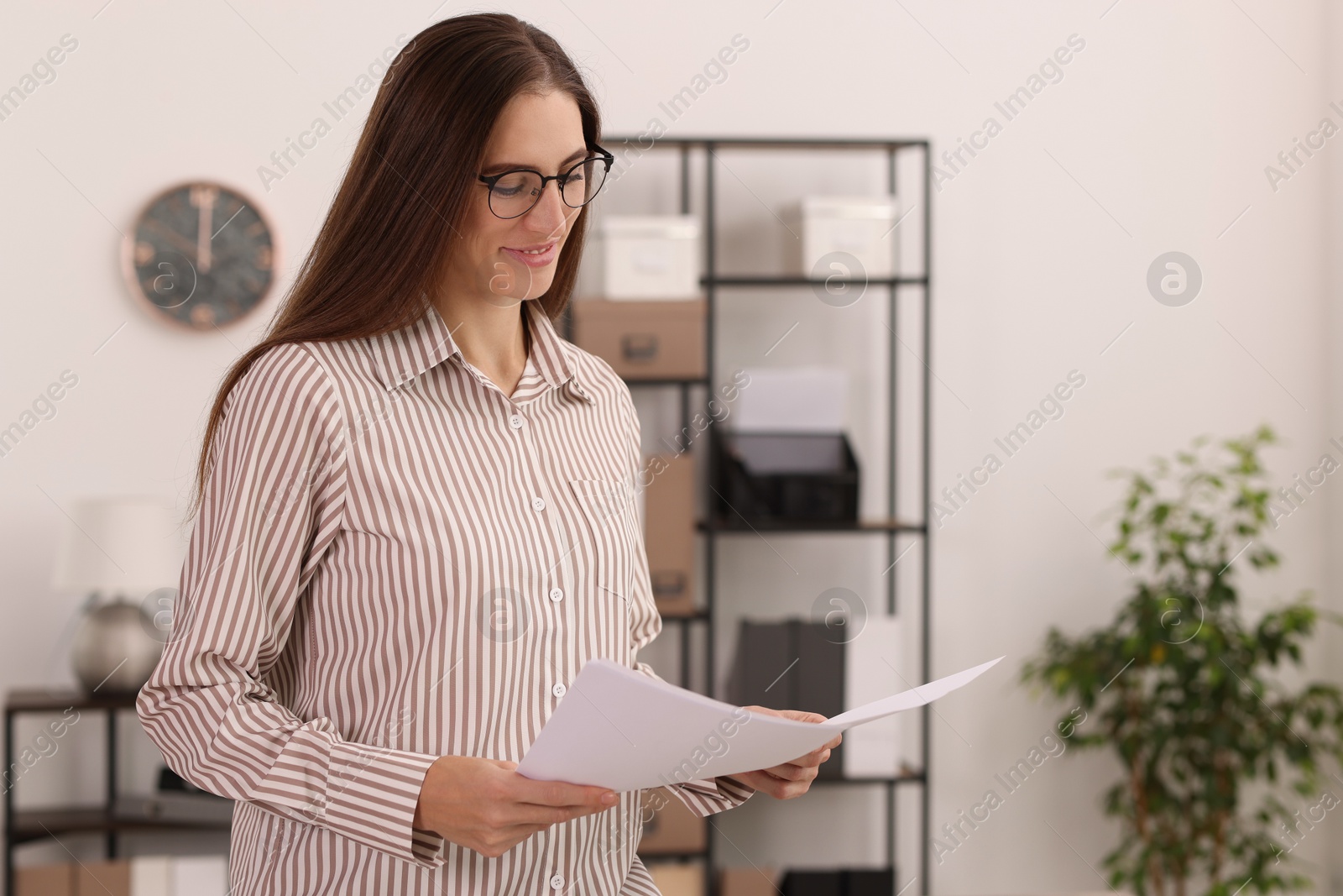 Photo of Portrait of banker with documents in office. Space for text