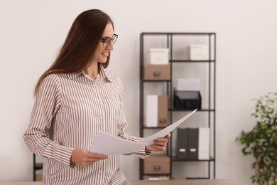 Photo of Portrait of banker with documents in office. Space for text