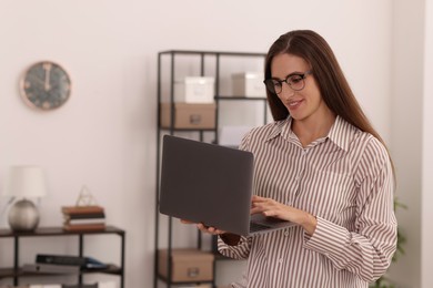 Photo of Banker with glasses using laptop in office. Space for text