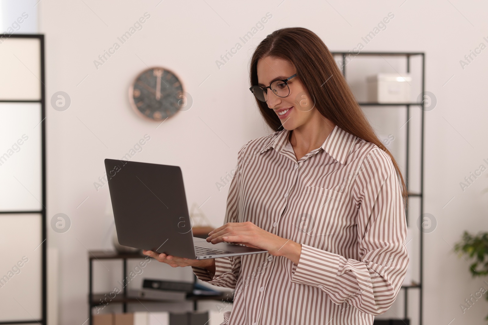 Photo of Banker with glasses using laptop in office