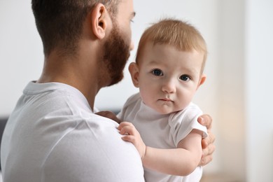 Photo of Dad with his cute little baby at home, closeup