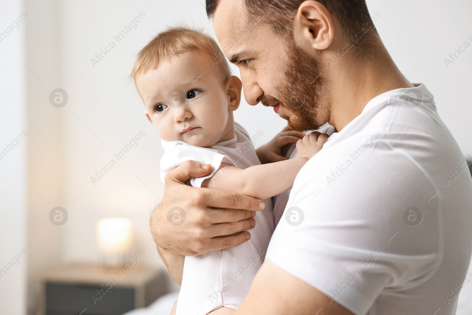 Photo of Dad with his cute little baby at home