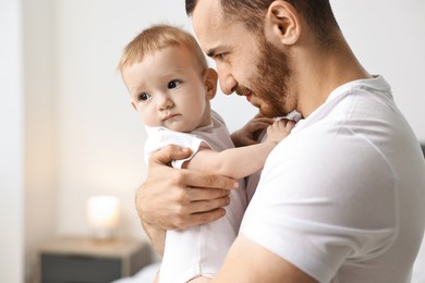 Photo of Dad with his cute little baby at home