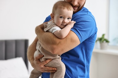 Photo of Dad with his cute little baby at home, closeup