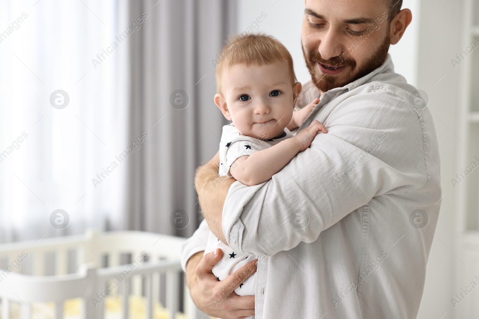 Photo of Dad with his cute little baby at home, closeup