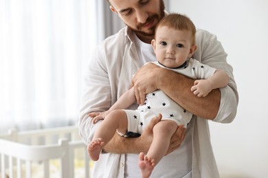 Photo of Dad with his cute little baby at home, closeup