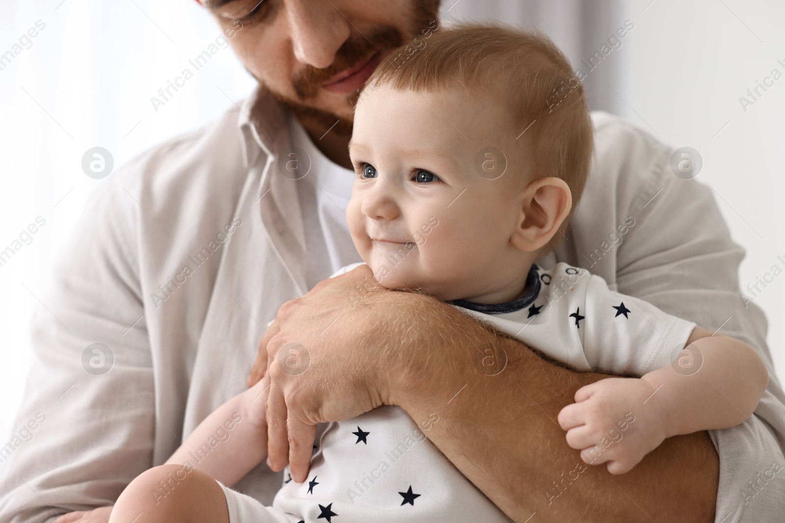 Photo of Dad with his cute little baby at home, closeup