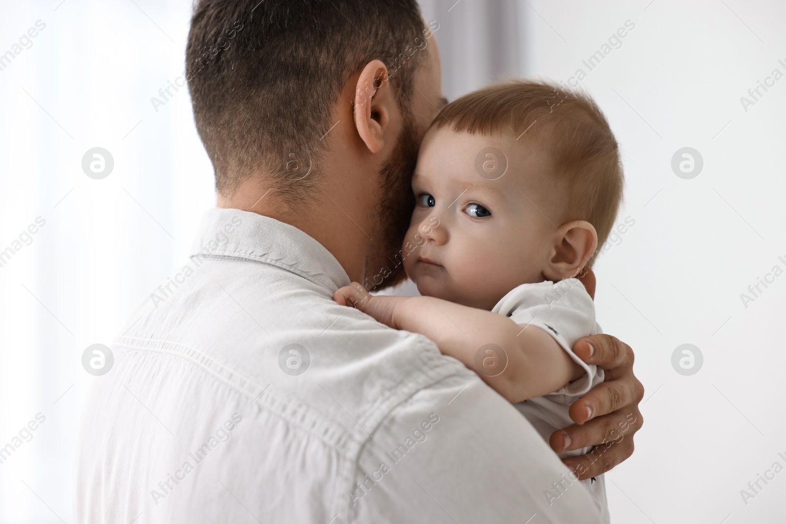 Photo of Dad with his cute little baby at home, closeup