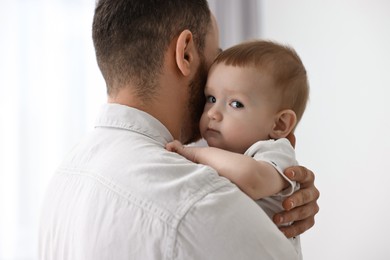 Dad with his cute little baby at home, closeup