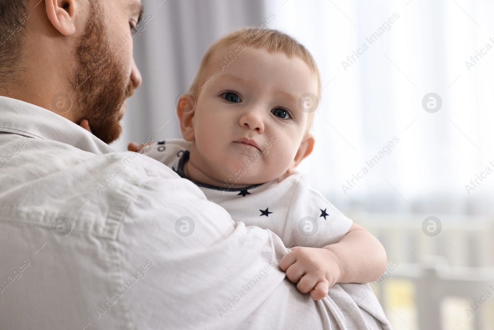 Photo of Dad with his cute little baby at home, closeup