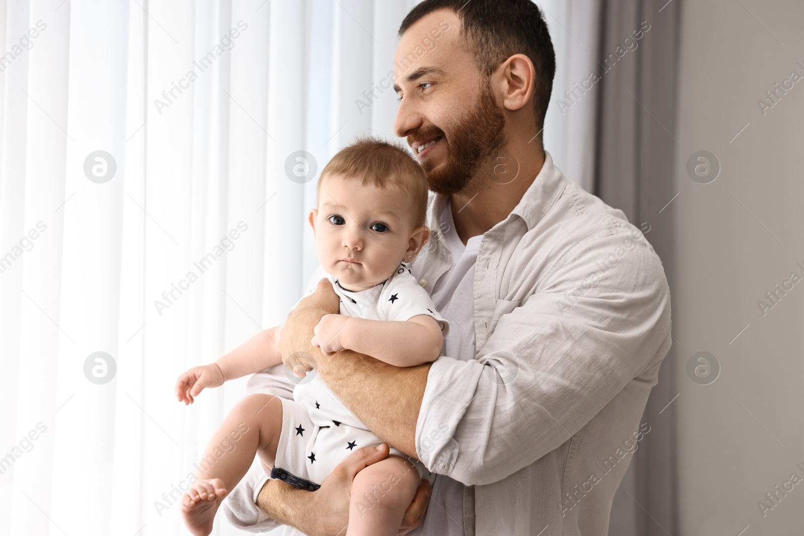 Photo of Dad with his cute little baby at home