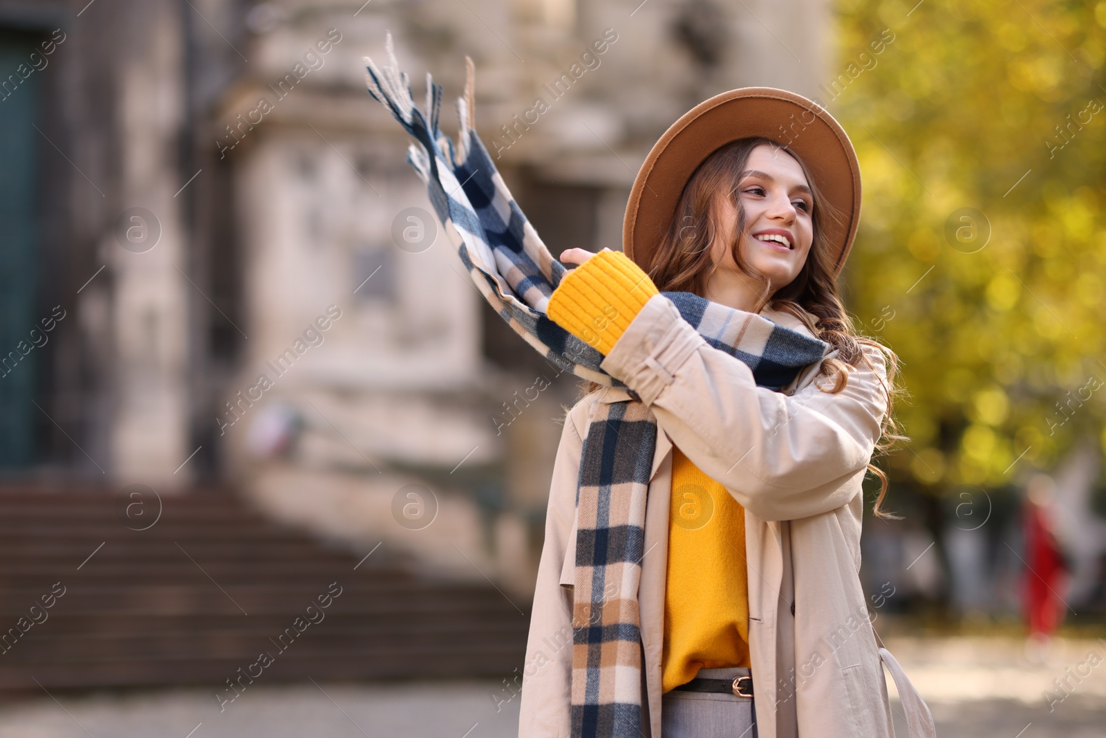 Photo of Charming young woman in stylish outfit on city street. Autumn season