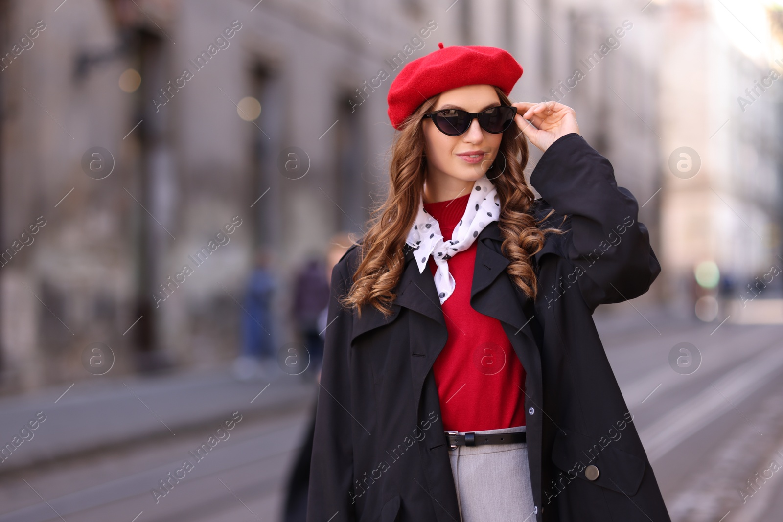 Photo of Charming young woman in stylish outfit on city street. Autumn season