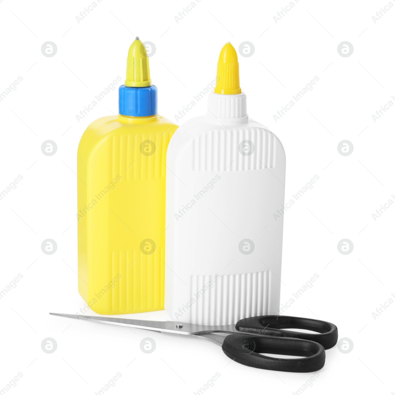 Photo of Bottles of glue and scissors isolated on white