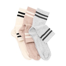 Photo of Different soft socks isolated on white, top view