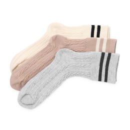 Photo of Different soft socks isolated on white, top view