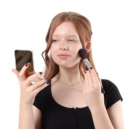 Photo of Teenage girl applying blusher with makeup brush on white background