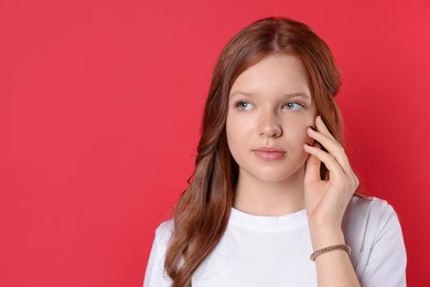 Photo of Portrait of beautiful teenage girl with natural makeup on red background. Space for text