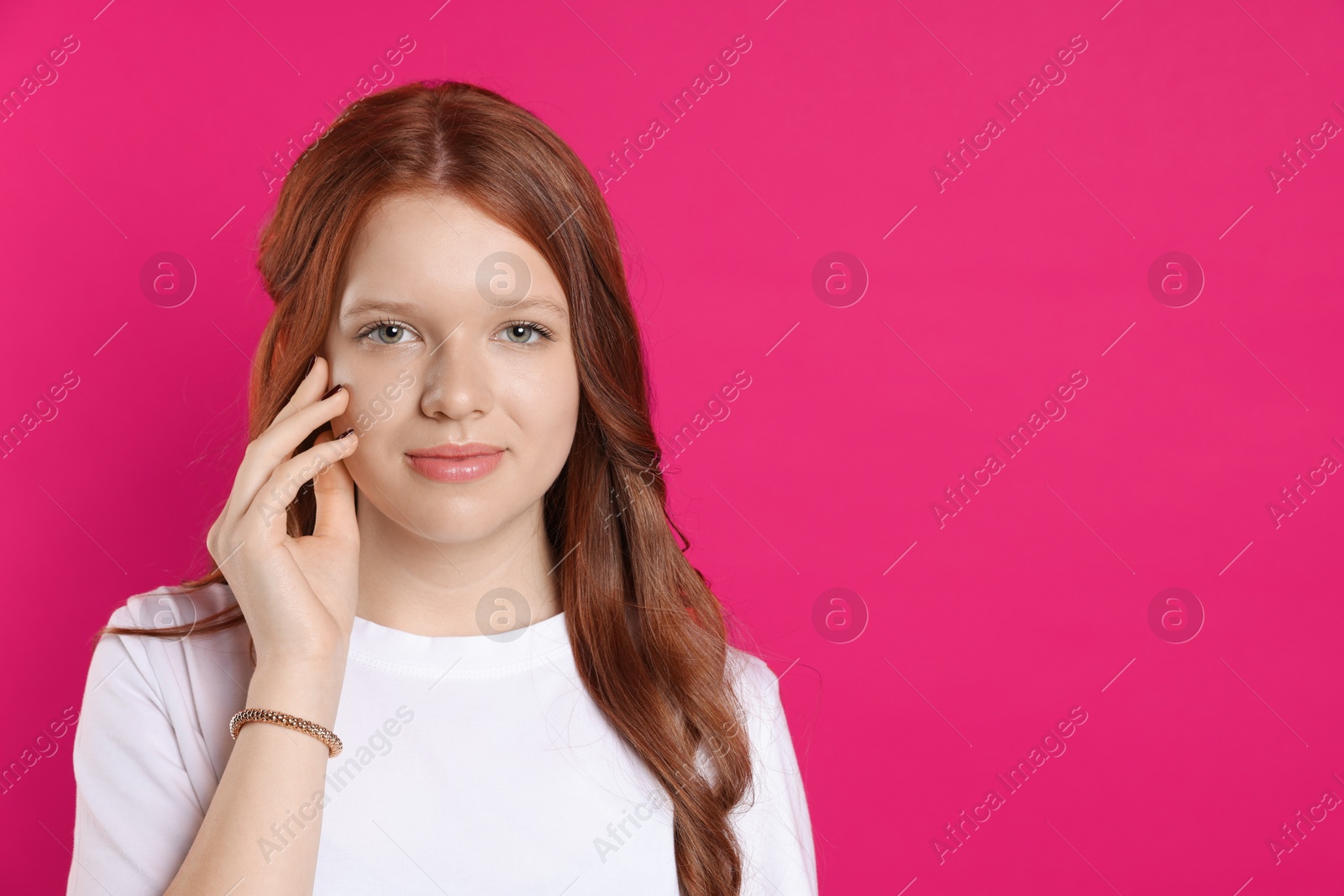 Photo of Portrait of beautiful teenage girl with natural makeup on red background. Space for text