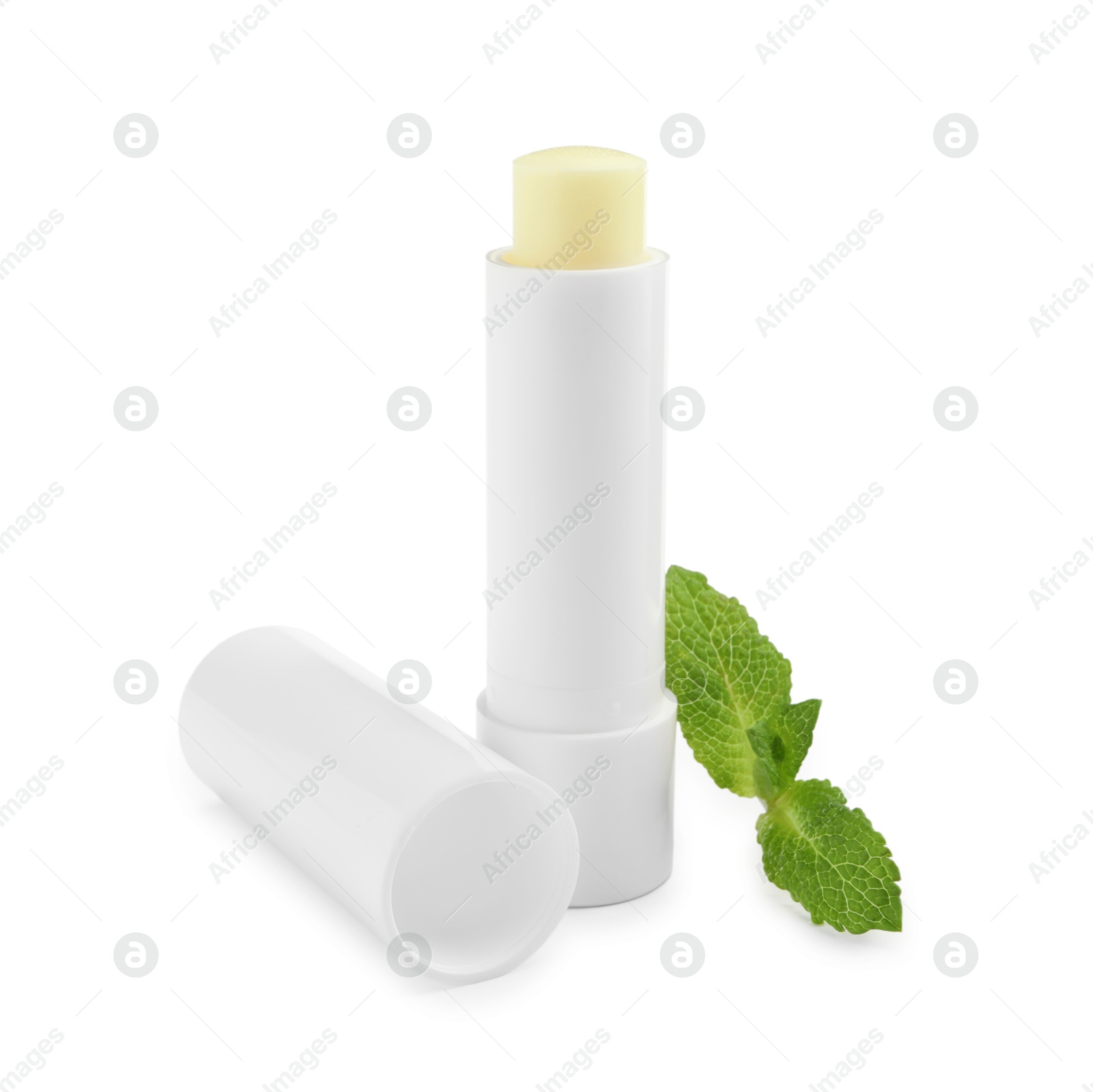 Photo of Mint lip balm and green leaves isolated on white. Cosmetic product