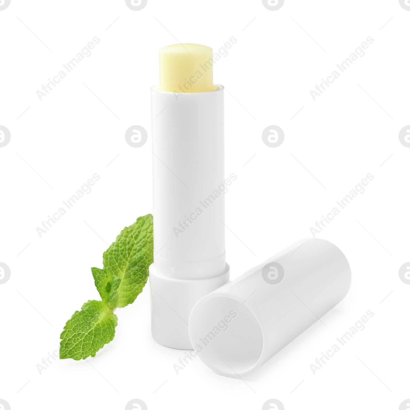 Photo of Mint lip balm and green leaves isolated on white. Cosmetic product