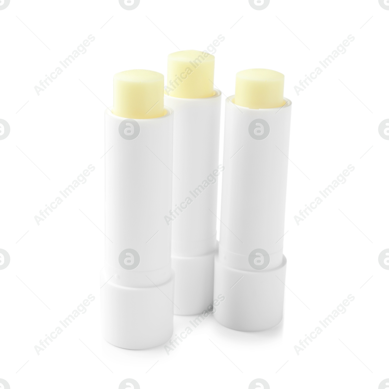 Photo of Lip balms isolated on white. Cosmetic product