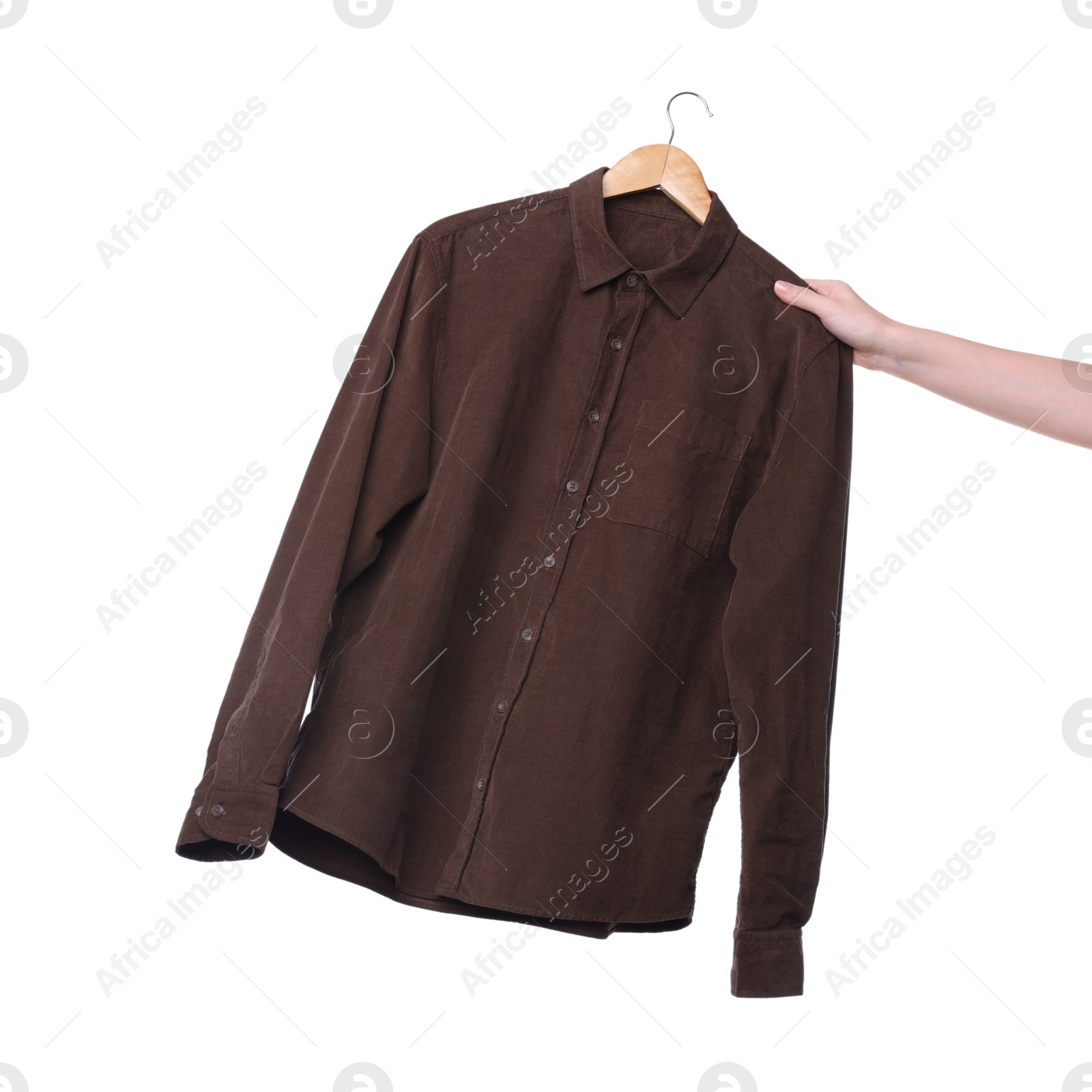 Photo of Woman holding hanger with brown shirt on white background, closeup