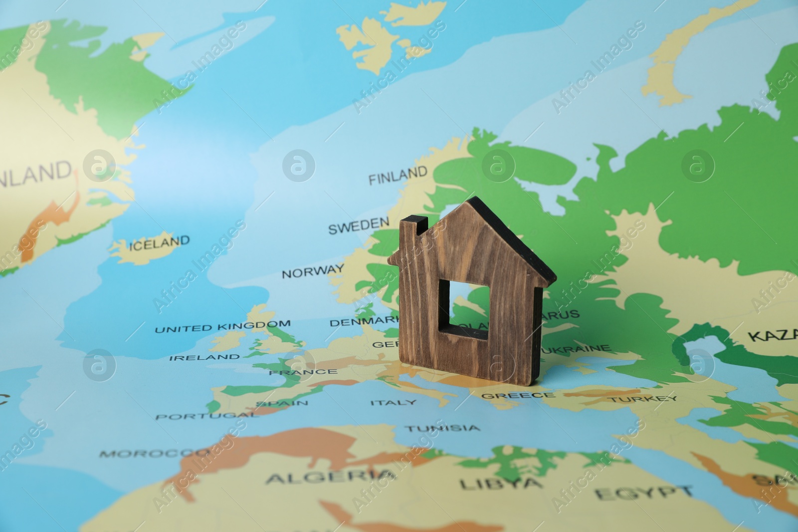 Photo of Wooden house model on world map. Accommodation search