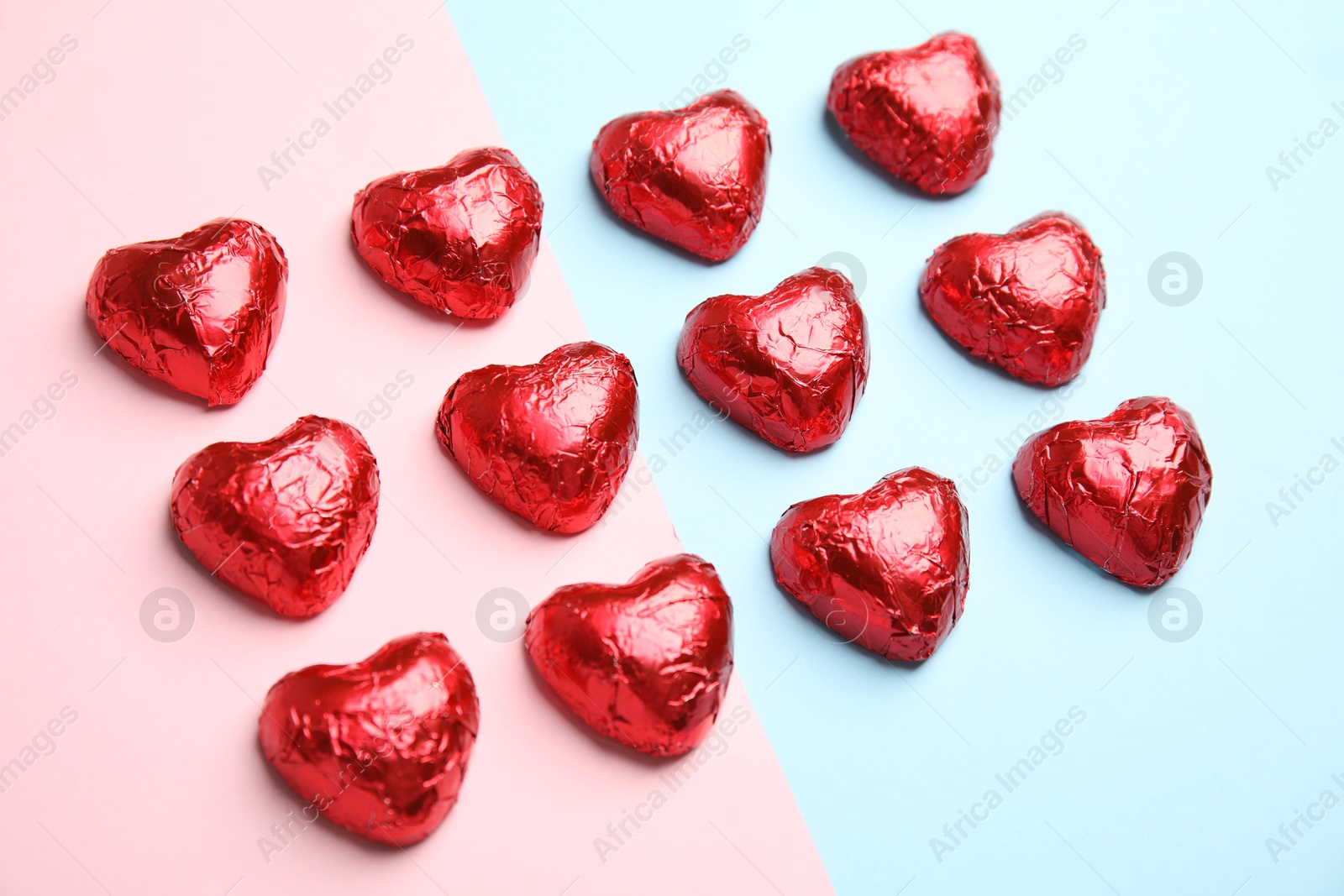 Photo of Heart shaped chocolate candies on color background. Valentine's day treat