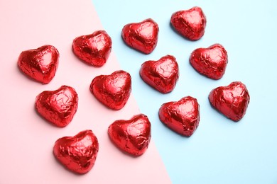 Photo of Heart shaped chocolate candies on color background. Valentine's day treat