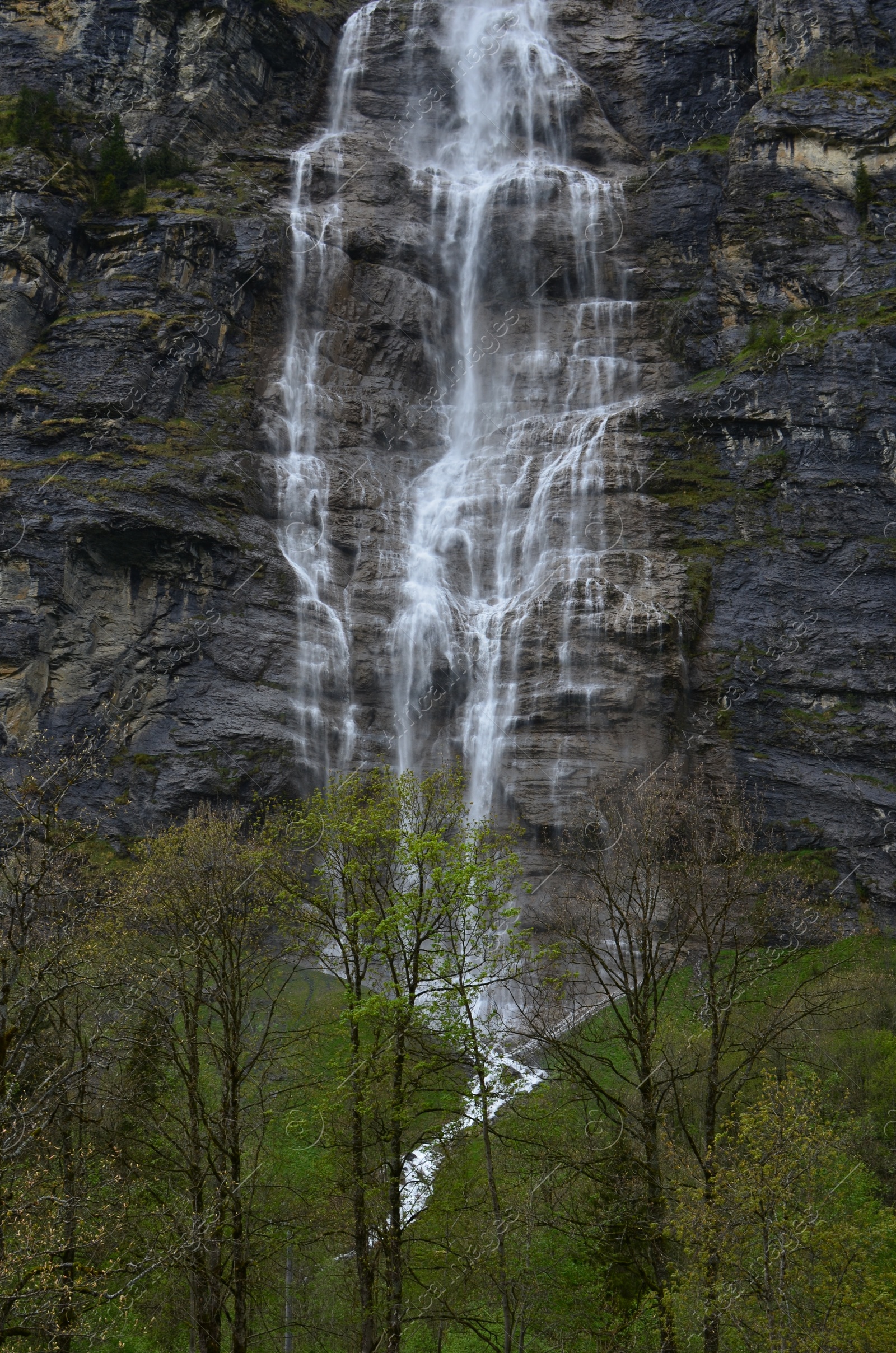 Photo of Picturesque view of beautiful mountain waterfall with moss outdoors