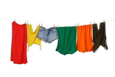 Photo of Different clothes drying on laundry line against white background