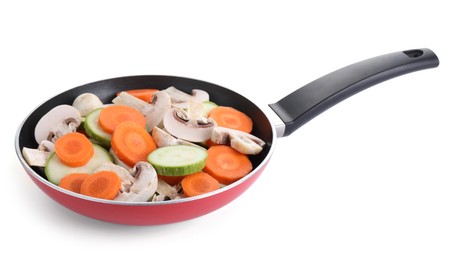 Photo of Frying pan with fresh vegetables and mushrooms isolated on white