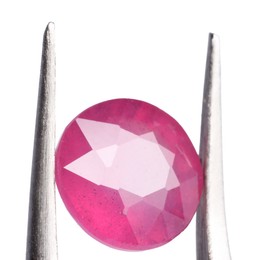 Photo of Tweezers with shiny pink gemstone isolated on white