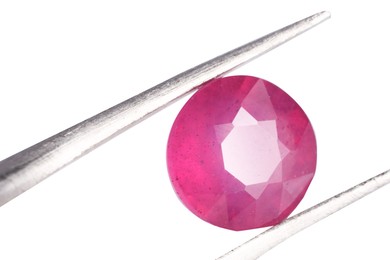 Photo of Tweezers with shiny pink gemstone isolated on white